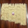 Blond hair weft bundles in multiple lengths ready for professional installations.