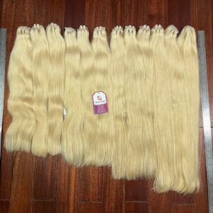 Blond hair weft bundles in multiple lengths ready for professional installations.