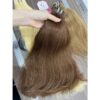 Close-up inspection of Sheen Hair Vietnam's Machine Weft Hair #6 Brown Extension